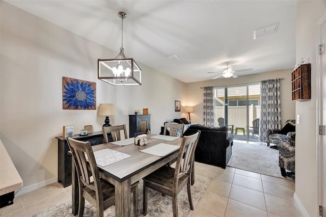 dining area featuring ceiling fan with notable chandelier and light tile patterned floors