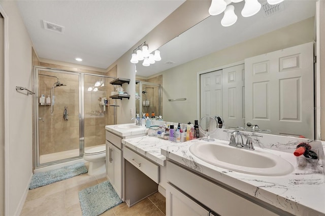 bathroom featuring tile patterned floors, vanity, an enclosed shower, and toilet