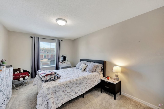 carpeted bedroom featuring a textured ceiling