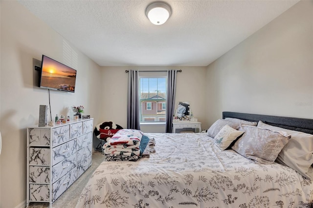 carpeted bedroom featuring a textured ceiling