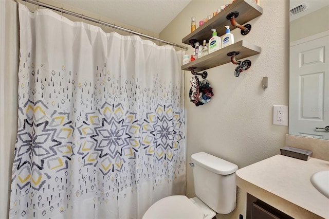 bathroom with a shower with shower curtain, vanity, and toilet