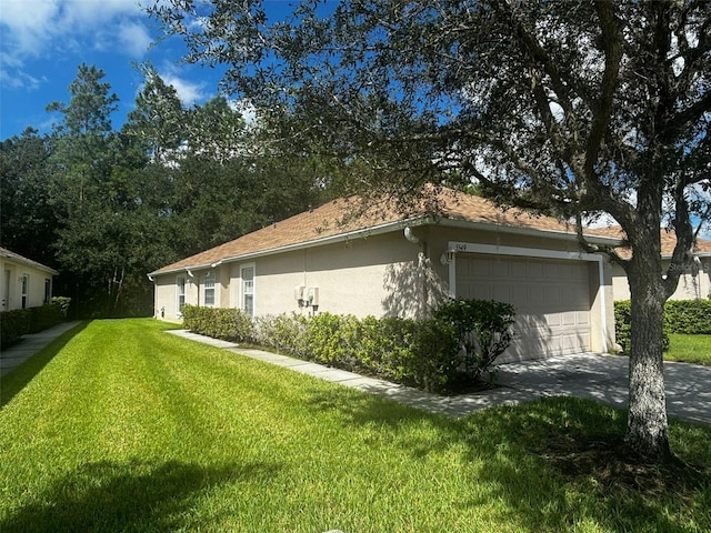 view of home's exterior featuring a yard and a garage