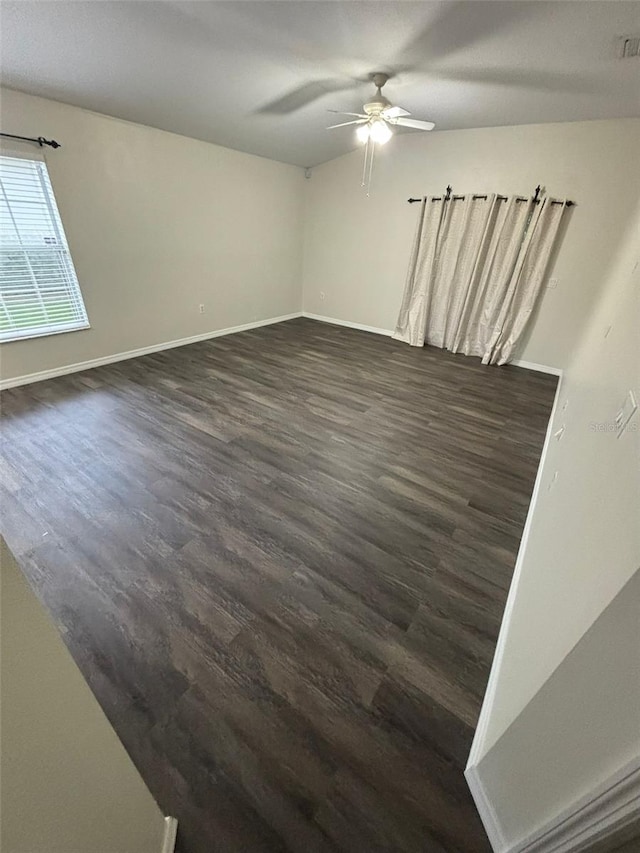 empty room featuring ceiling fan and dark wood-type flooring