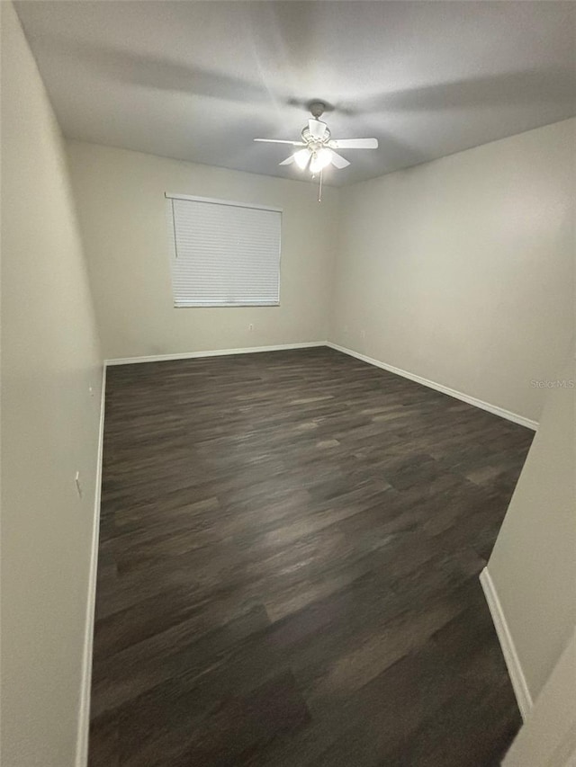 spare room featuring ceiling fan and dark hardwood / wood-style floors