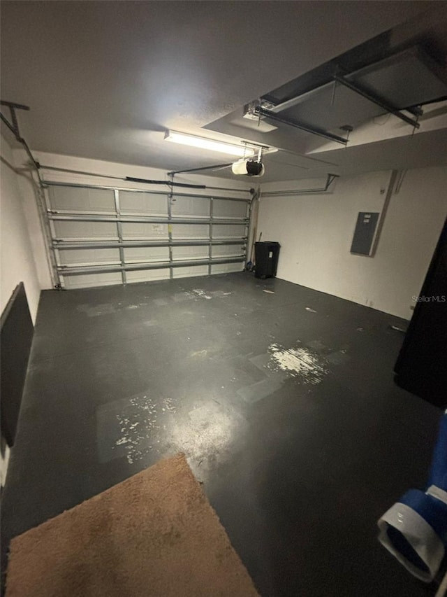 garage with electric panel and a garage door opener