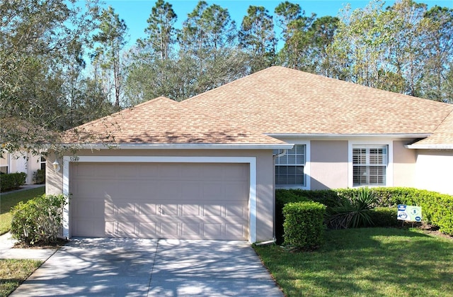 single story home with a front yard and a garage