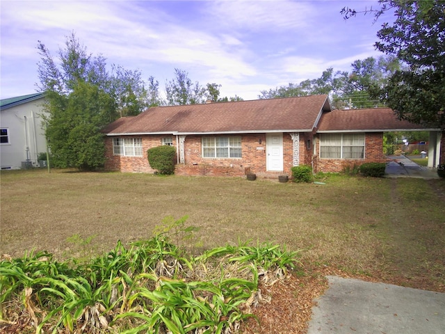 ranch-style home featuring a front yard