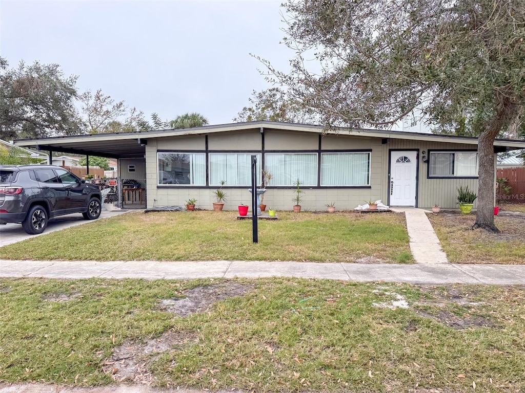 view of front of house with a front lawn and a carport