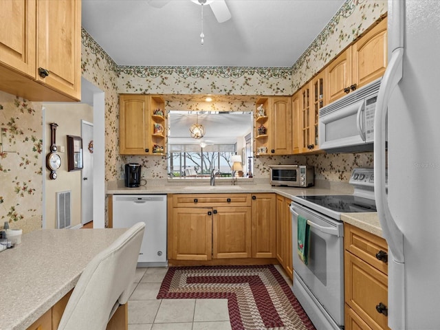 kitchen with light tile patterned floors, white appliances, ceiling fan, and sink