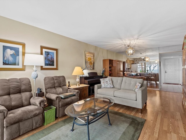 living room featuring a chandelier and hardwood / wood-style floors