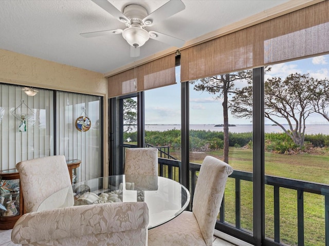 sunroom / solarium featuring ceiling fan