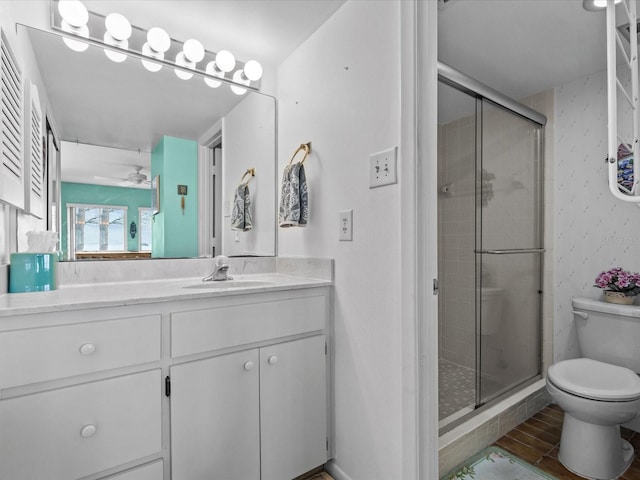 bathroom featuring vanity, toilet, and walk in shower