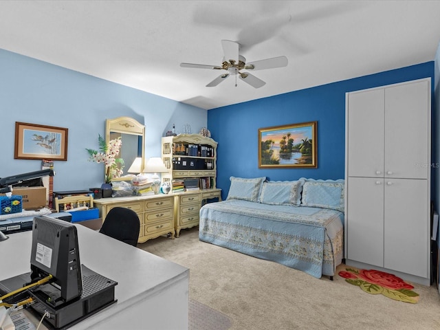 bedroom featuring ceiling fan, light carpet, and a closet