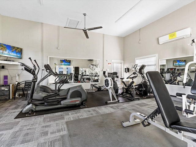 gym with carpet, a wall unit AC, and ceiling fan