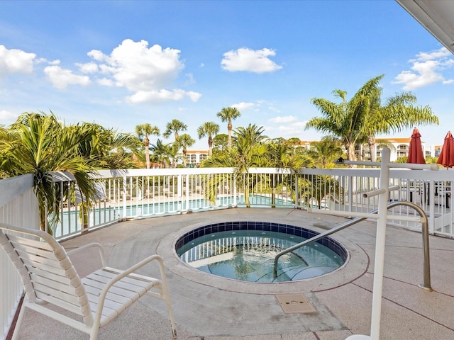 view of swimming pool featuring a community hot tub