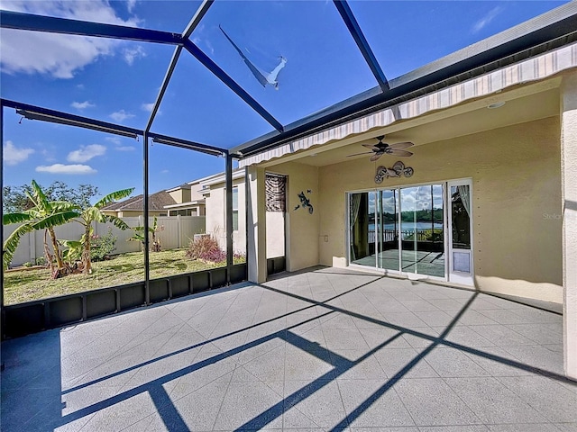 view of patio / terrace with ceiling fan and glass enclosure