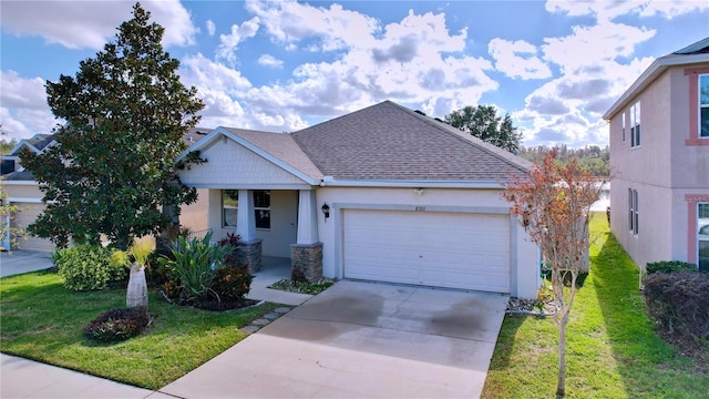 view of front of home featuring a front yard and a garage