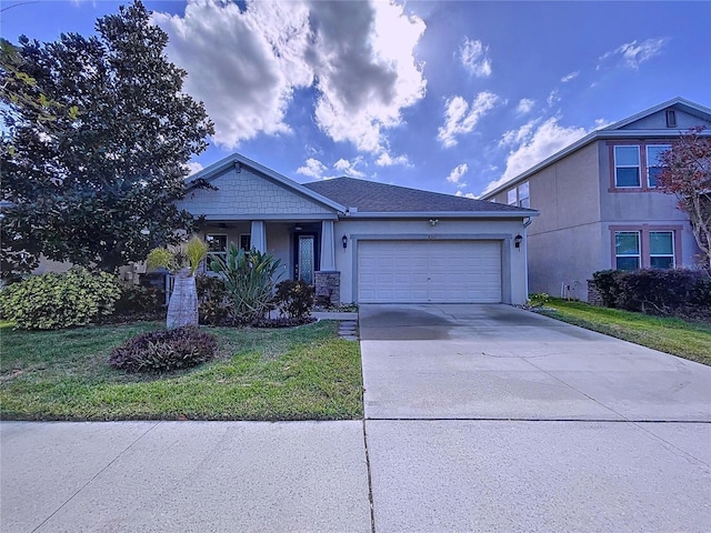 view of front facade with a front yard and a garage