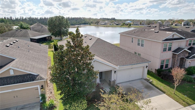 birds eye view of property with a water view