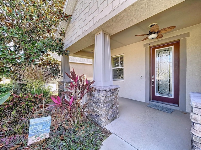 entrance to property featuring ceiling fan