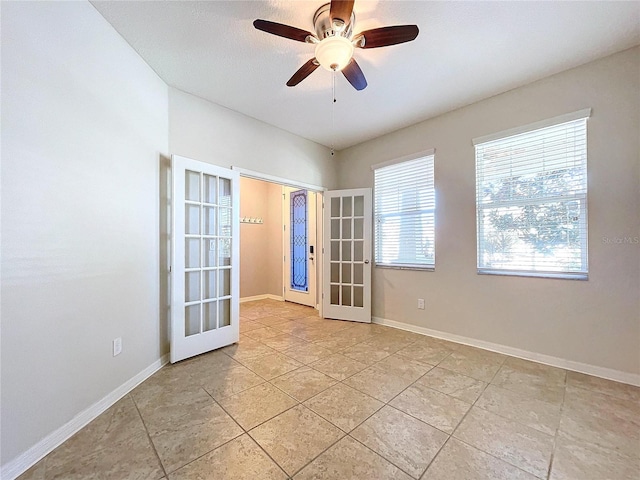 spare room with ceiling fan, light tile patterned floors, and french doors