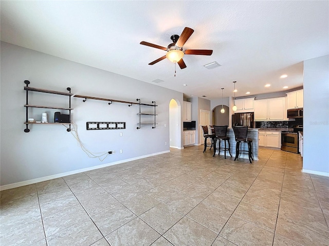 unfurnished living room with ceiling fan and light tile patterned flooring