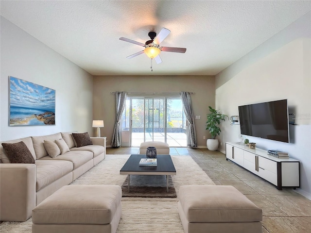 tiled living room featuring ceiling fan and a textured ceiling