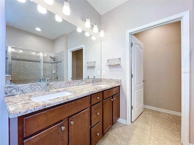 bathroom featuring an enclosed shower and vanity