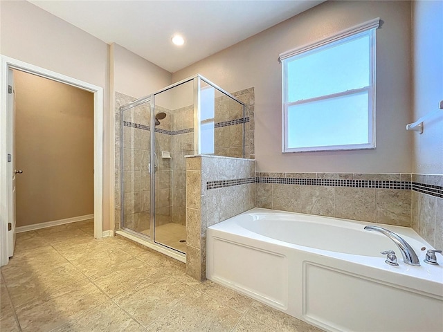 bathroom featuring shower with separate bathtub