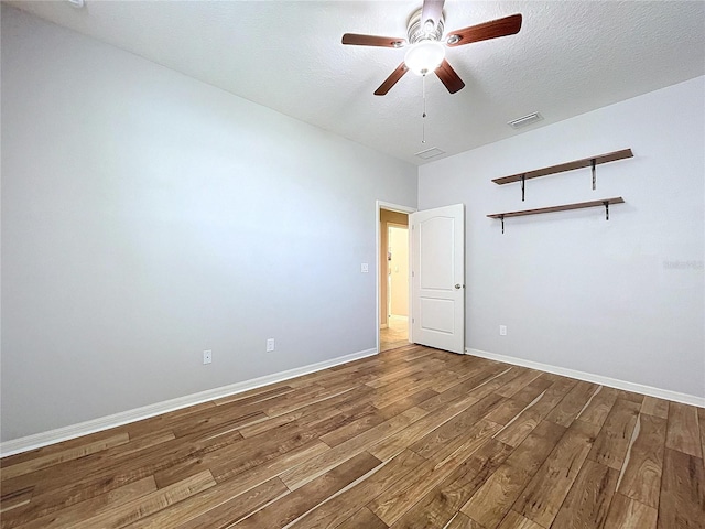 empty room featuring hardwood / wood-style flooring and ceiling fan