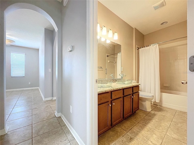 full bathroom with tile patterned floors, toilet, vanity, and shower / tub combo