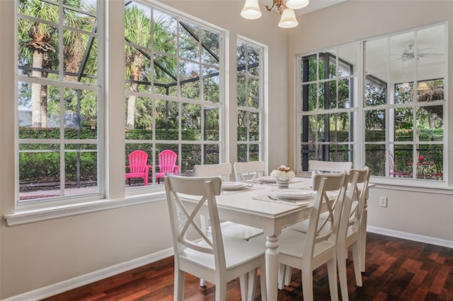 sunroom / solarium featuring a wealth of natural light and a chandelier