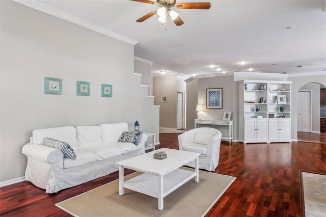 living room with dark wood-type flooring, ceiling fan, and ornamental molding