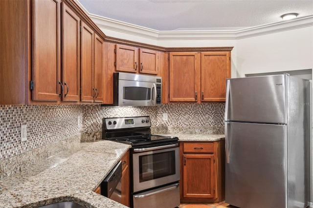 kitchen featuring tasteful backsplash, light stone countertops, appliances with stainless steel finishes, and ornamental molding