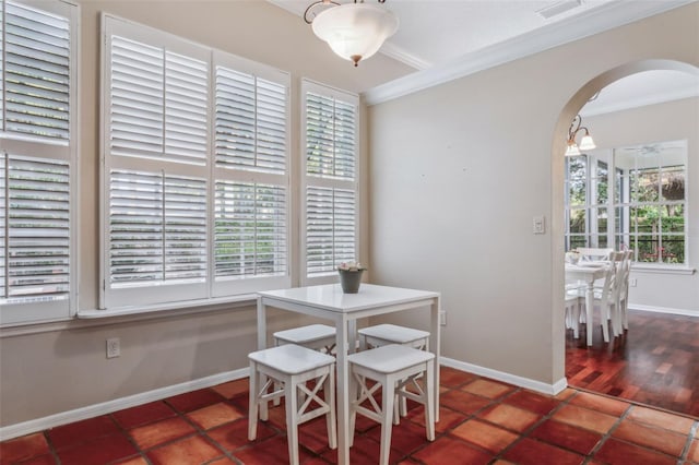 tiled dining area featuring ornamental molding