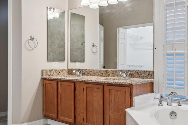 bathroom featuring vanity and a washtub