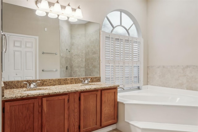 bathroom with vanity and independent shower and bath