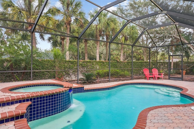 view of swimming pool with an in ground hot tub, a patio, and glass enclosure