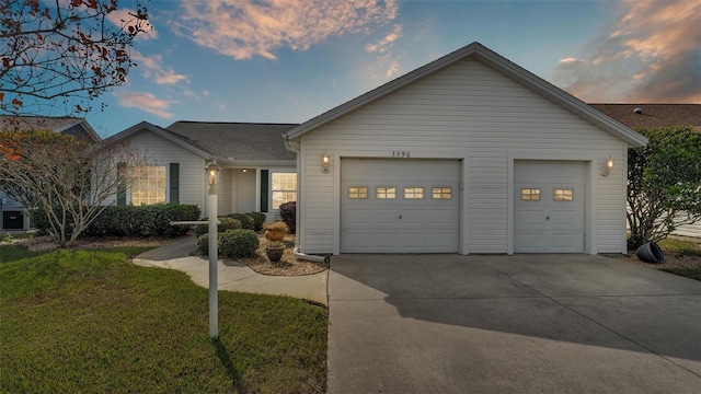 ranch-style house with a lawn and a garage