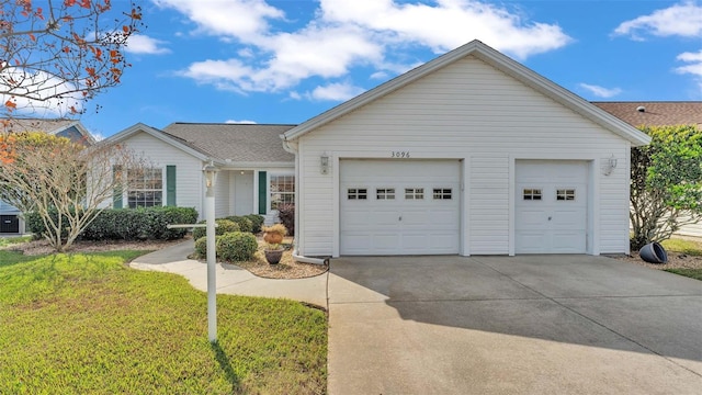 ranch-style house featuring a garage and a front lawn