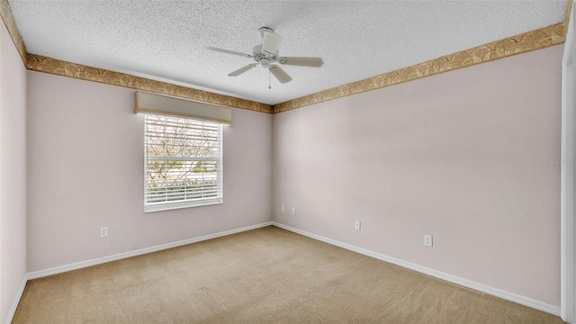 carpeted empty room with a textured ceiling and ceiling fan