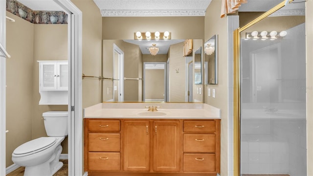 bathroom featuring a textured ceiling, vanity, toilet, and walk in shower