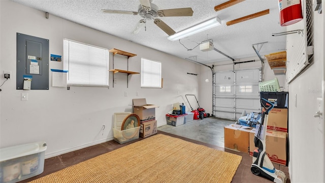 garage with electric panel, a garage door opener, and ceiling fan