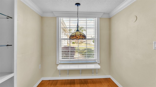 room details featuring ornamental molding, a textured ceiling, and hardwood / wood-style flooring