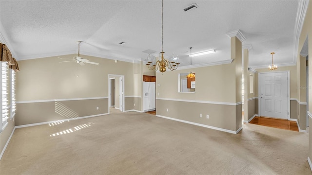 empty room with carpet flooring, ceiling fan with notable chandelier, lofted ceiling, and crown molding