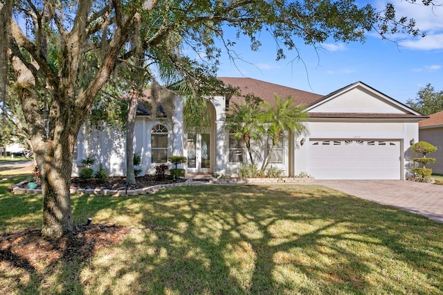 ranch-style home with a garage and a front lawn