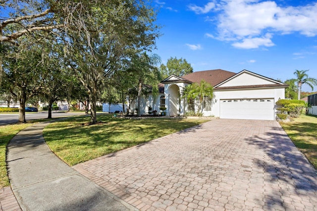 ranch-style home with a garage and a front yard