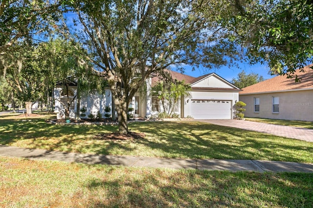 single story home featuring a garage and a front lawn