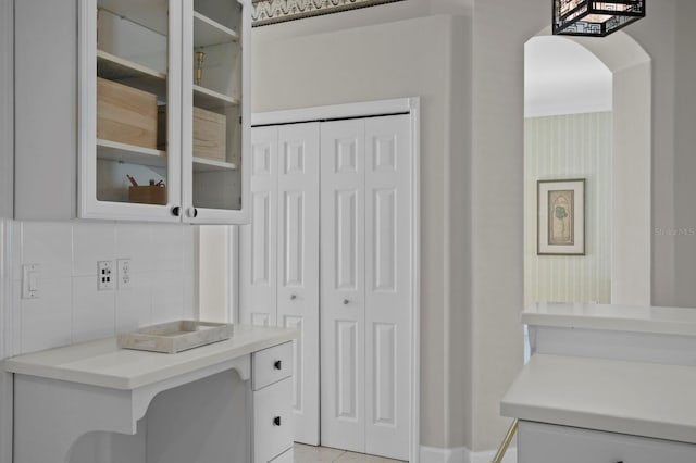 interior space featuring white cabinets and backsplash