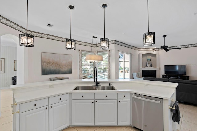 kitchen with sink, decorative light fixtures, stainless steel dishwasher, and white cabinets